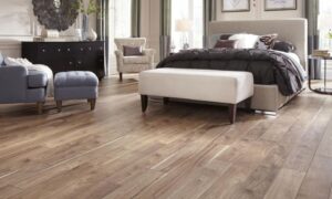 Stylish bedroom featuring a comfortable bed, seating area, and wooden flooring.